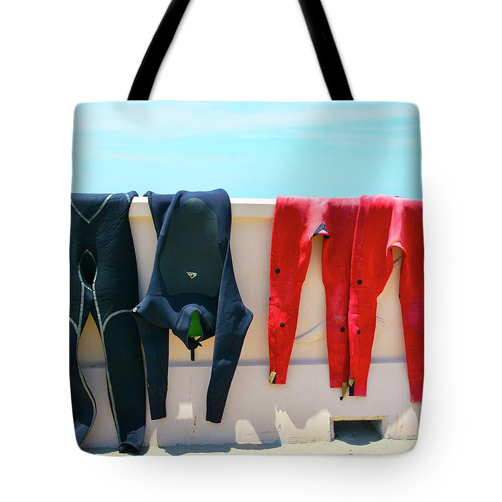 Wetsuits Surfer Colorful Beach Wall Sea Blue Sky Red Yellow Sport Water Ocean Waves Human Form Tote Bag featuring the photograph Hang Ten by Jennifer Wright