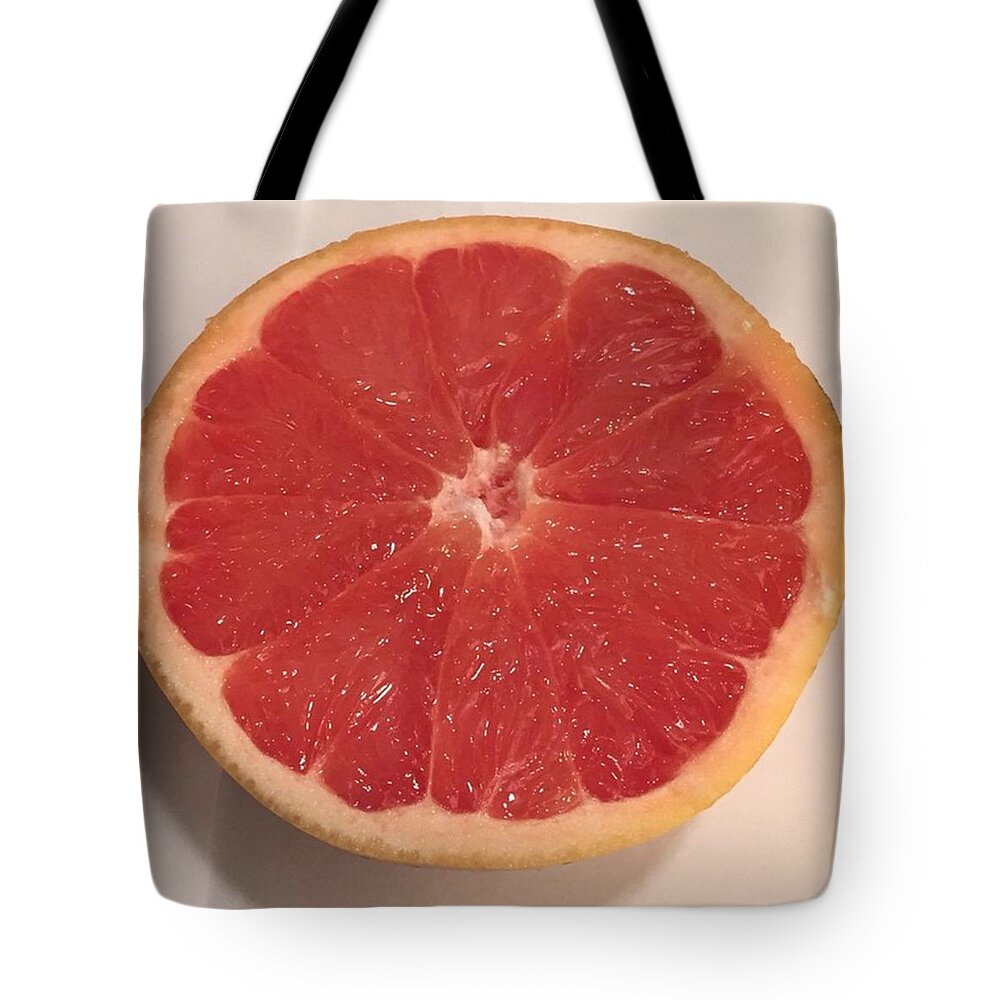 Fruits Tote Bag featuring the photograph A Perfect Looking Grapefruit by Stephanie Ventura