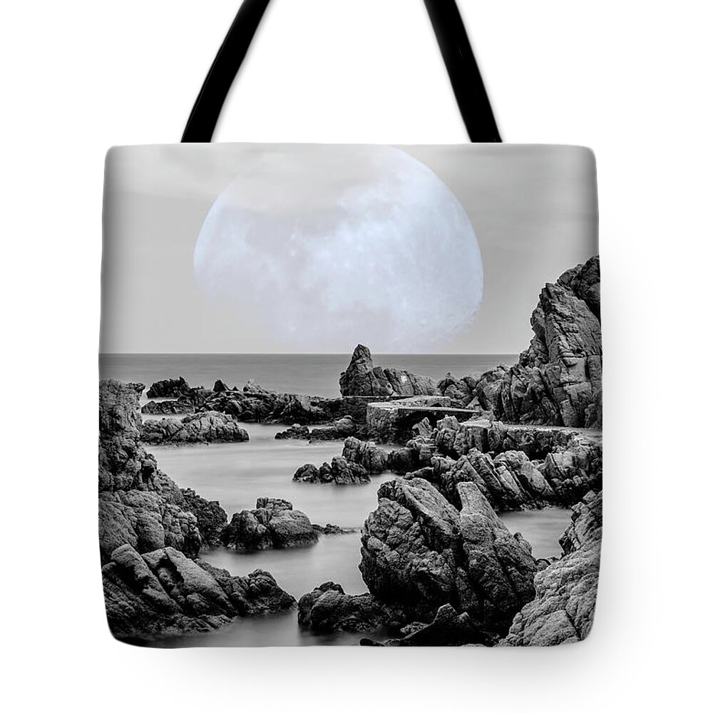 Spain Tote Bag featuring the photograph La Luna over Cala Canyet by Wolfgang Stocker