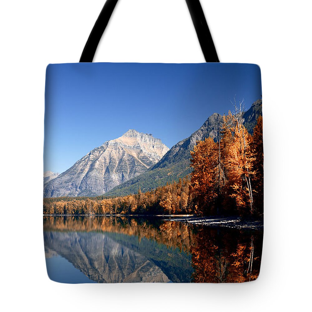 Lawrence Tote Bag featuring the photograph Lake McDonald Autumn by Lawrence Boothby