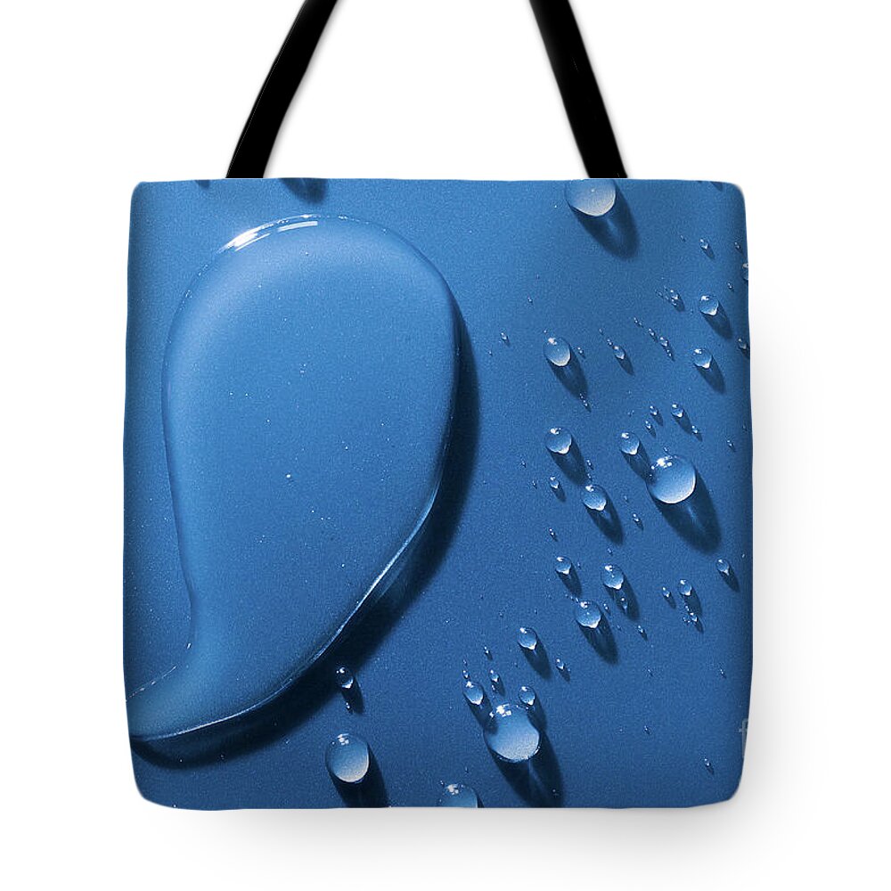 Water Tote Bag featuring the photograph Large and small water droplets viewed from above by Simon Bratt