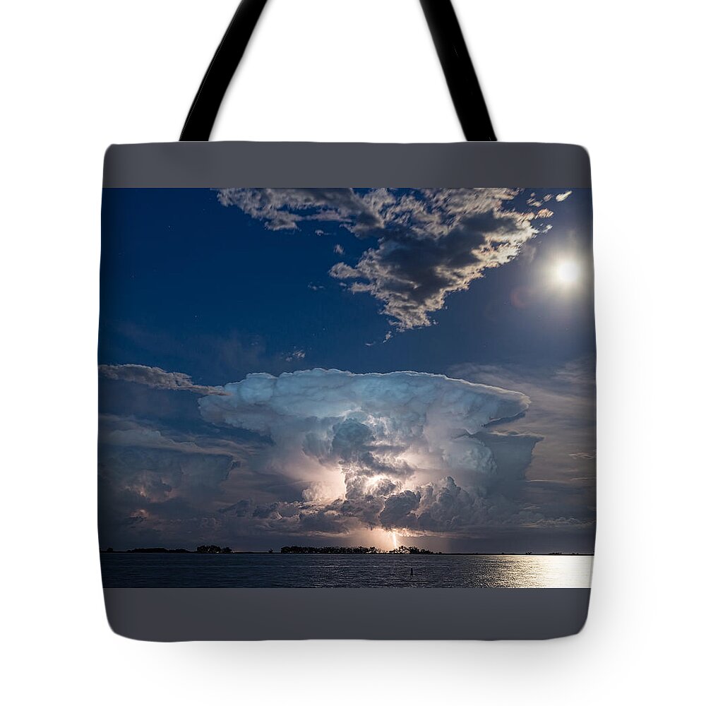 Storm Tote Bag featuring the photograph Lightning Striking Thunderstorm Cell and Full Moon by James BO Insogna