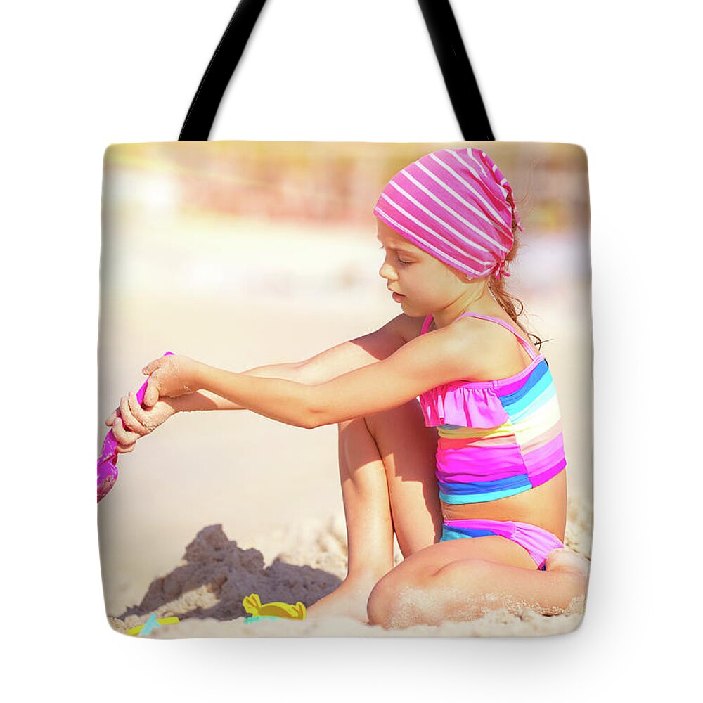 Active Tote Bag featuring the photograph Little girl playing on the beach by Anna Om