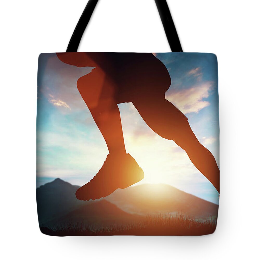 Man Tote Bag featuring the photograph Man running in the mountains at the sunset. by Michal Bednarek