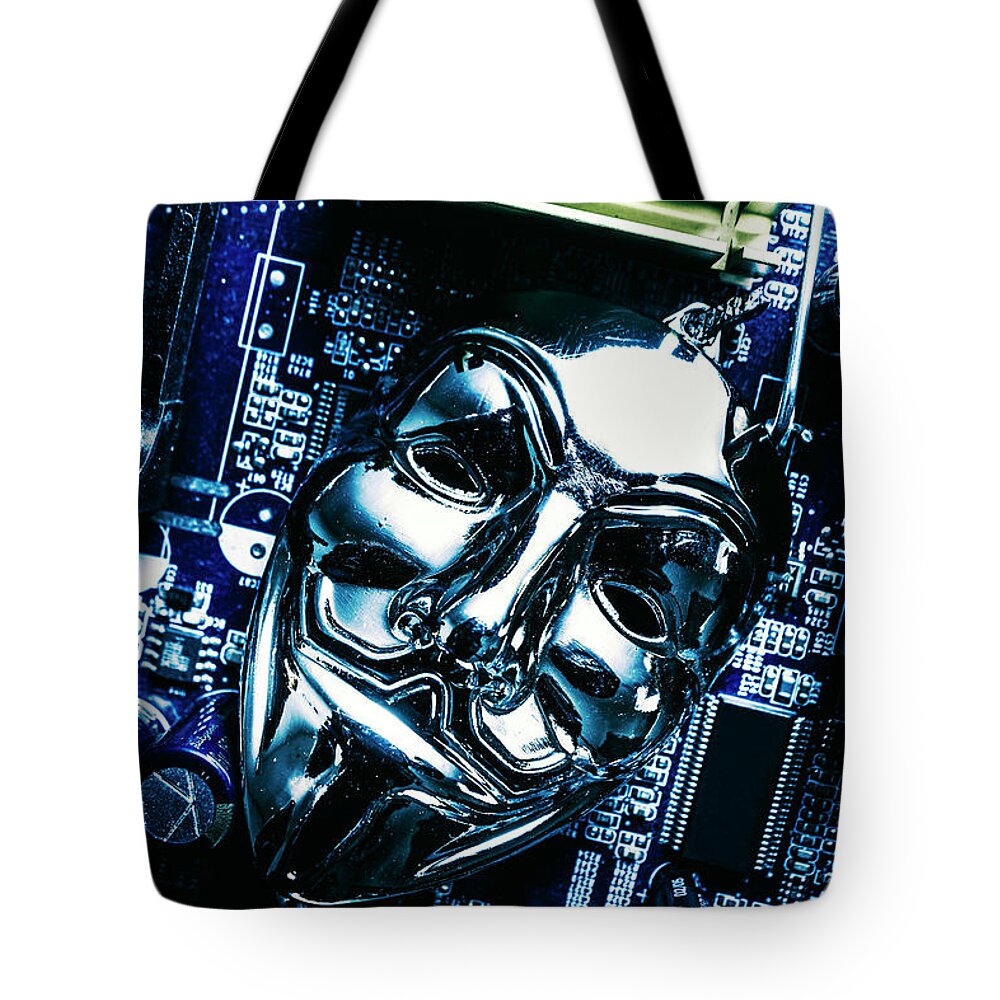 Cyber Tote Bag featuring the photograph Metal anonymous mask on motherboard by Jorgo Photography