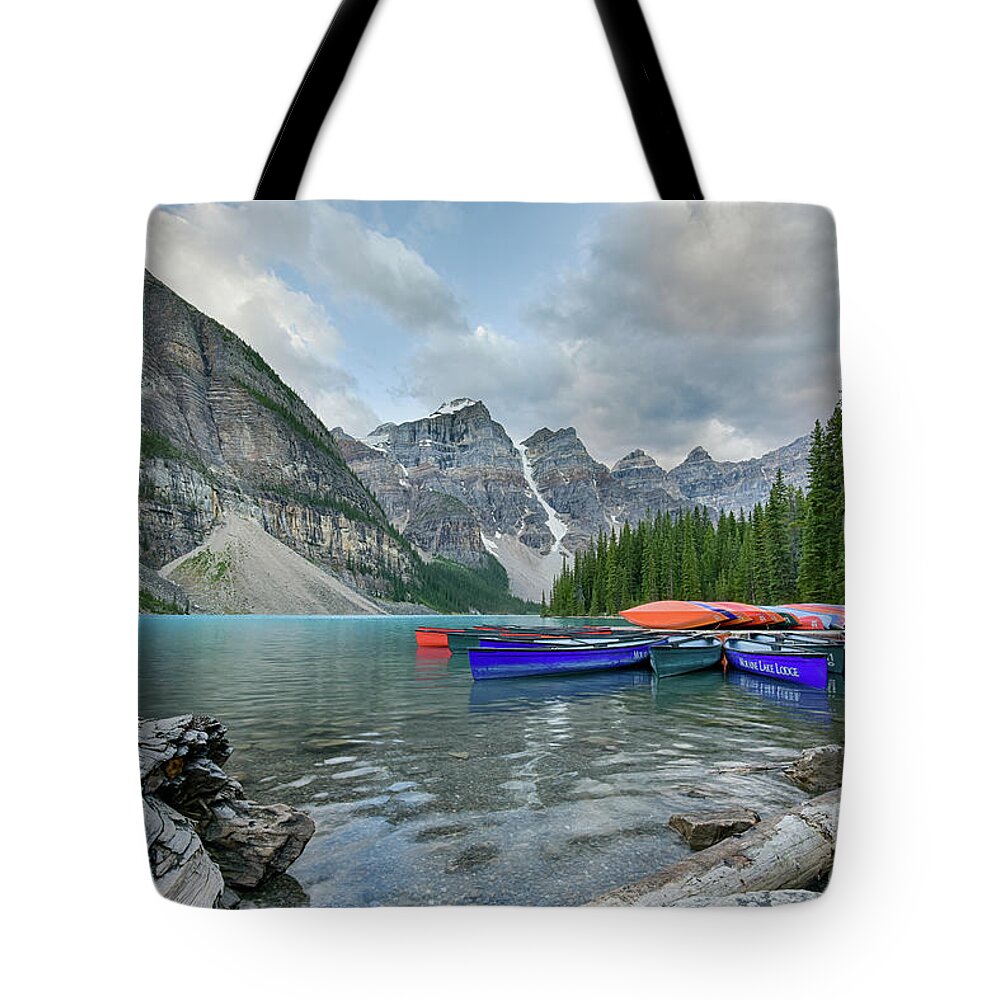 Moraine Lake Tote Bag featuring the photograph Moraine logs and canoes by Paul Quinn