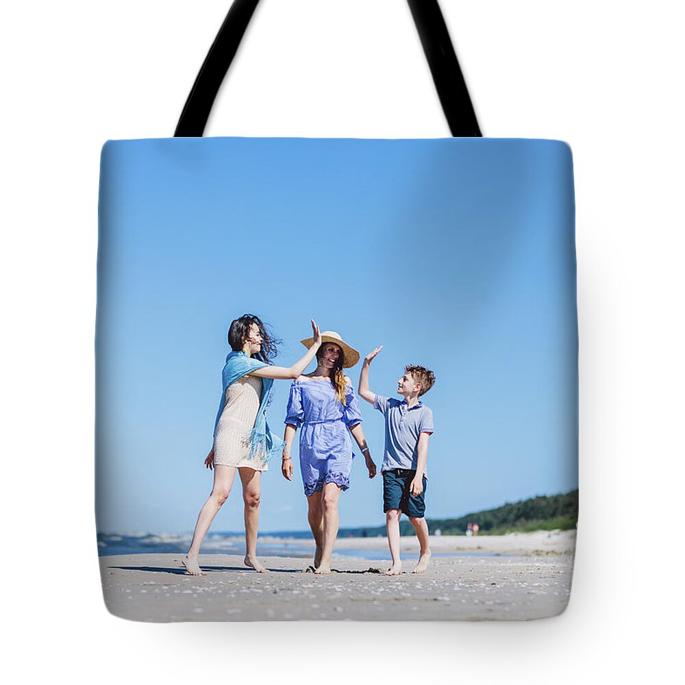 Family Tote Bag featuring the photograph Mother with children walking by the sea by Michal Bednarek