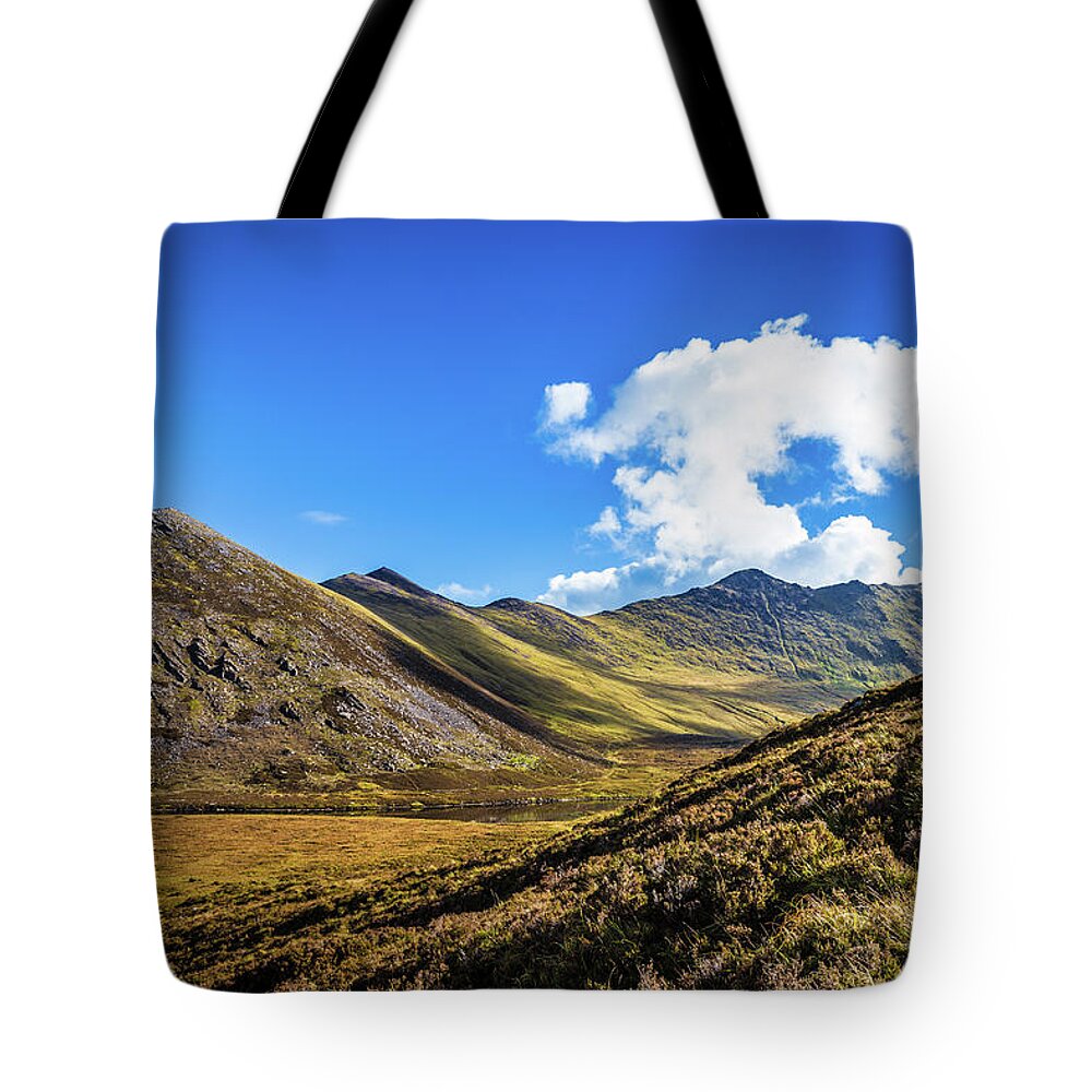 Beenkeragh Tote Bag featuring the photograph Mountain range and valleys in Kerry in Ireland on a sunny day wi by Semmick Photo