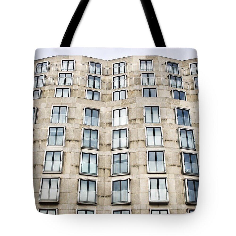 Apartment Tote Bag featuring the photograph Multi-storey building by Tom Gowanlock