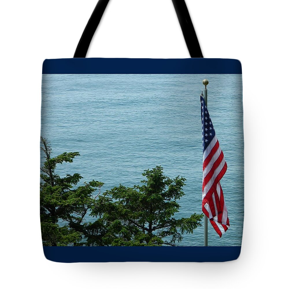 Oregon Tote Bag featuring the photograph No Wind For Flag by Gallery Of Hope 