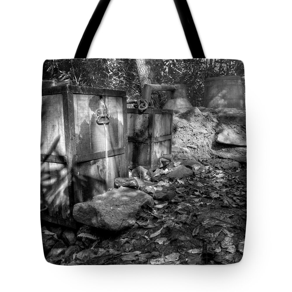 Moonshine Tote Bag featuring the photograph North Carolina Moonshine Still in Black and White by Greg and Chrystal Mimbs