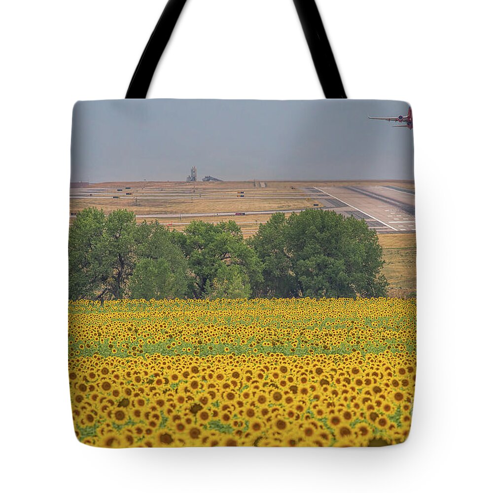 Sunflower Fields Tote Bag featuring the photograph O'er Fields of Gold by Jim Garrison