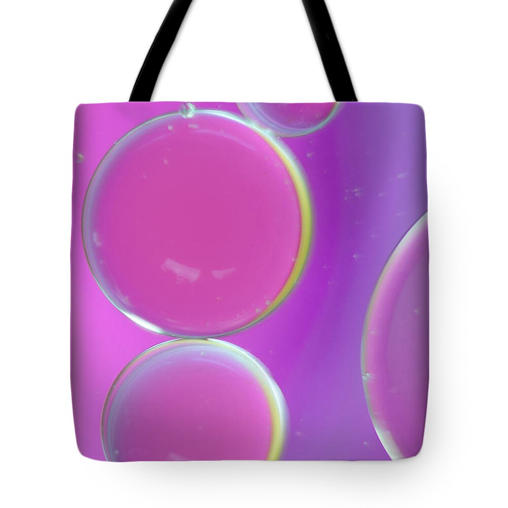 Water Tote Bag featuring the photograph Oil on water abstract by Andy Myatt