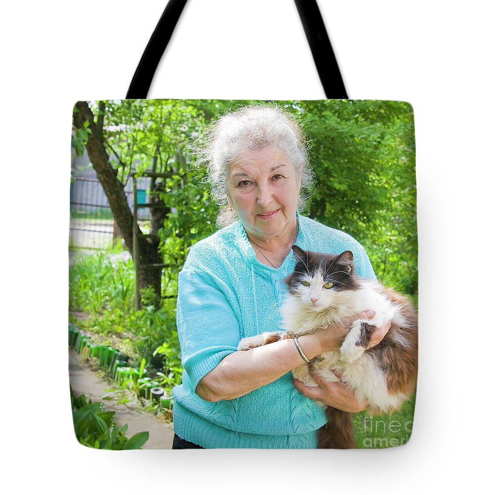 People Tote Bag featuring the photograph Old lady with cat by Irina Afonskaya