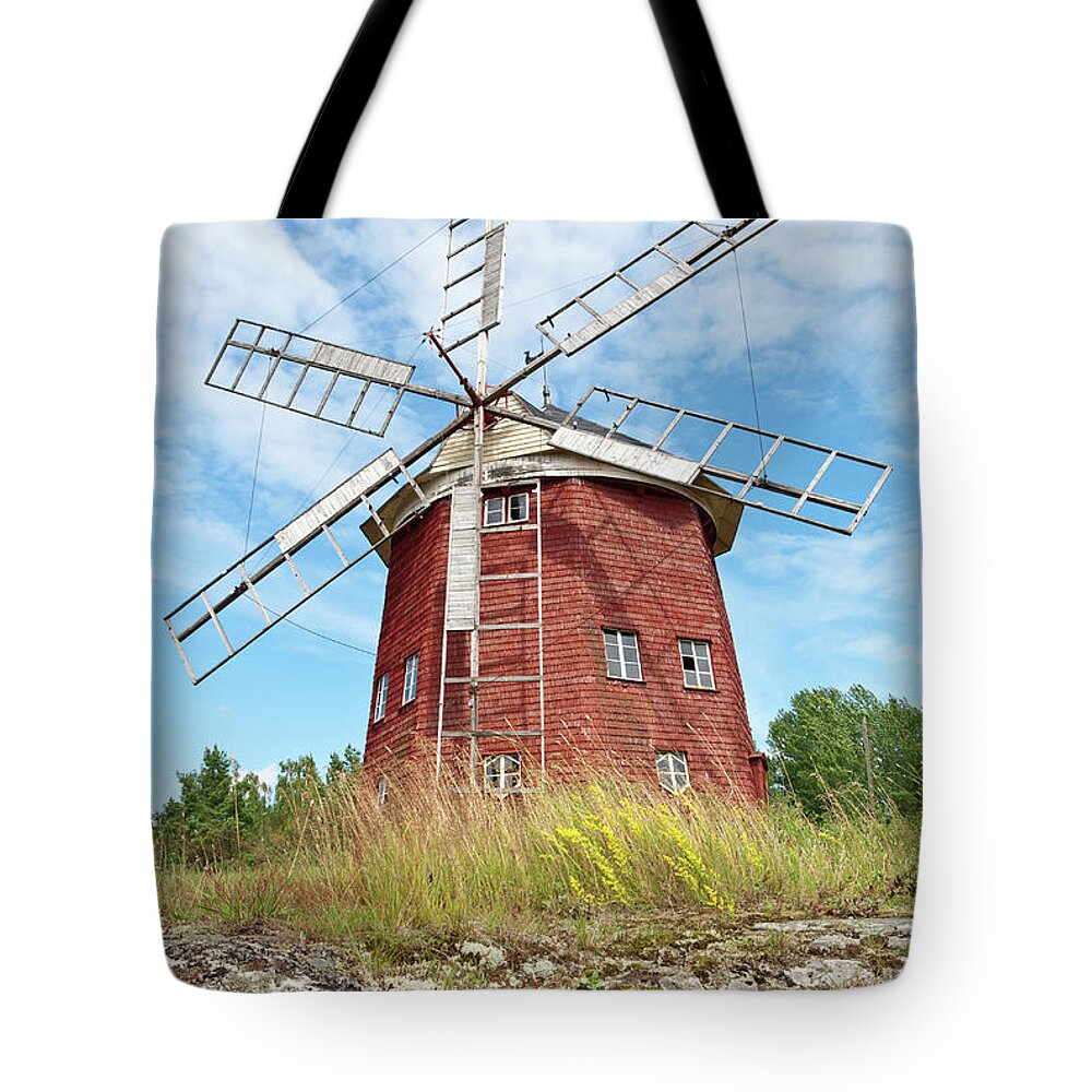 Windmill Tote Bag featuring the photograph Old wooden windmill in Sweden by GoodMood Art