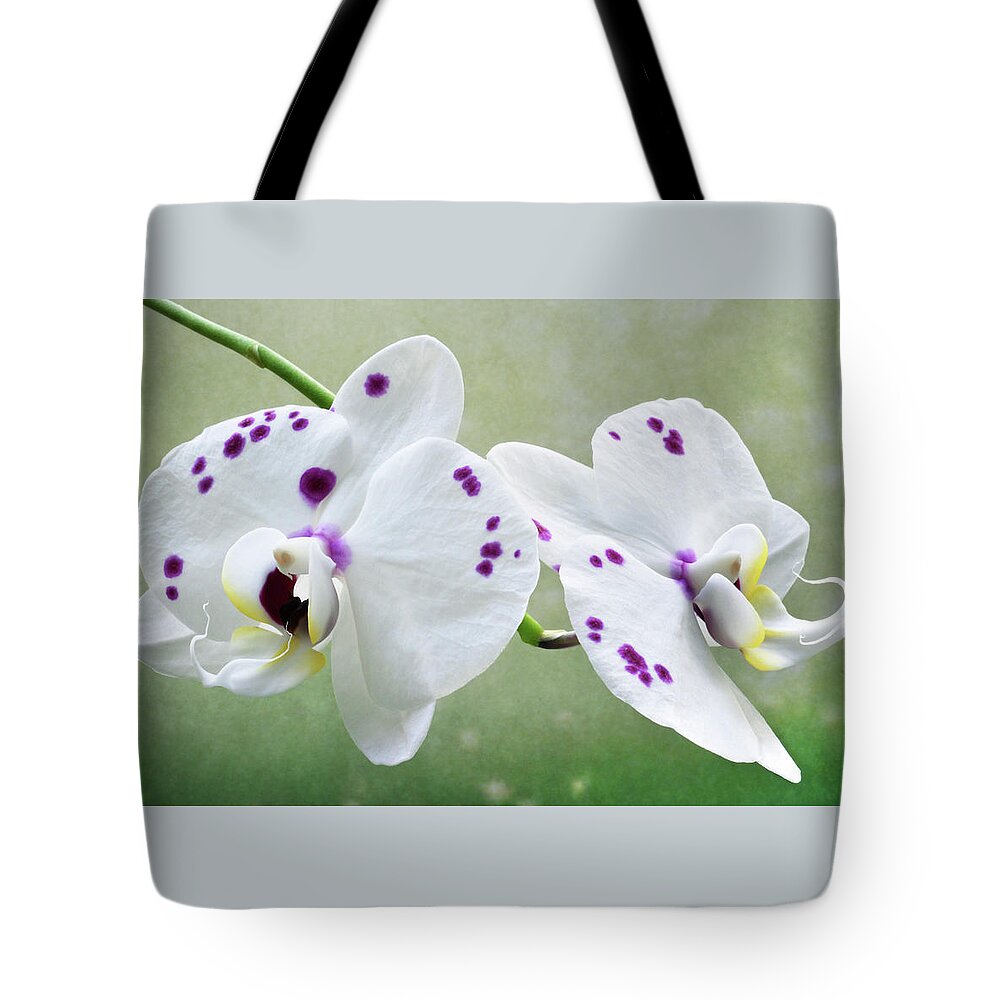 Orchids Tote Bag featuring the photograph Orchids With Purple Specks by Terence Davis