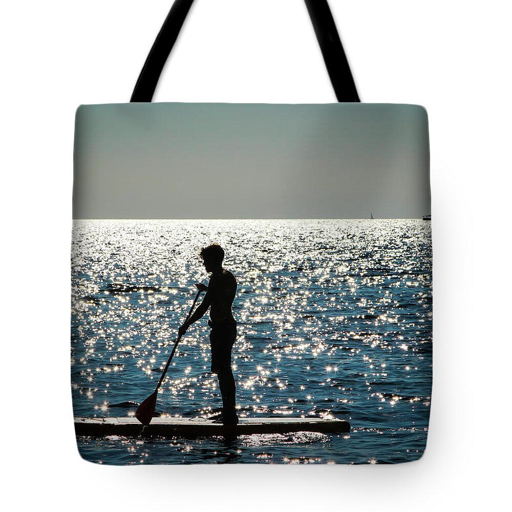 Paddleboarder Tote Bag featuring the photograph Paddleboarder by Aashish Vaidya