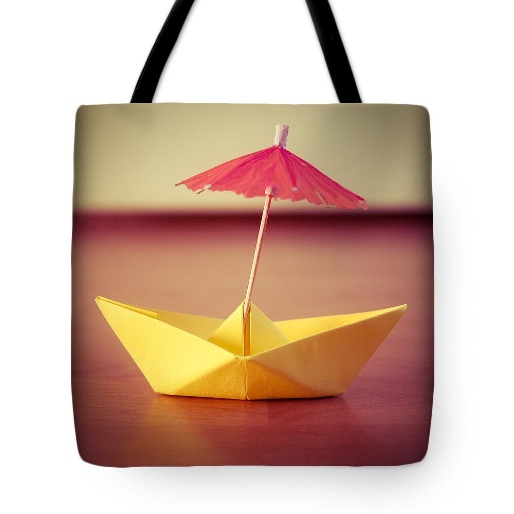 Paperboat Umbrella Tote Bag featuring the photograph Paper Boat Umbrella by Janine Pauke
