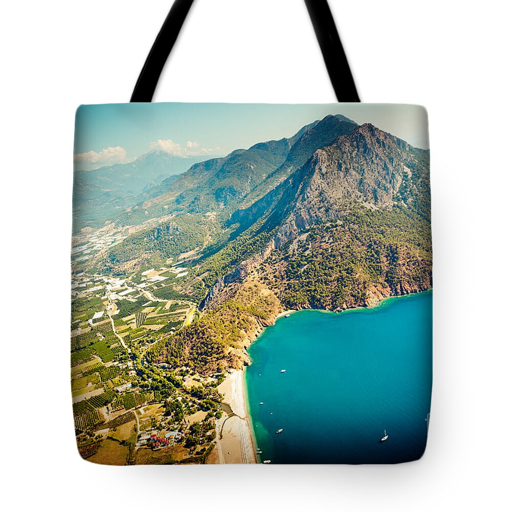 Water Tote Bag featuring the photograph Paragliding Fly above laguna Artmif.lv by Raimond Klavins