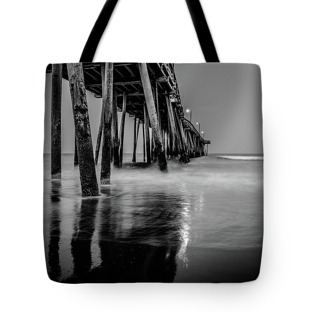 Black And White Tote Bag featuring the photograph Pier Reflections by Larkin's Balcony Photography