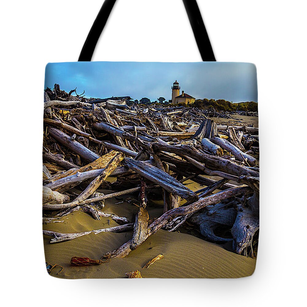 Romantic Coquille River Lighthouse Tote Bag featuring the photograph Piles Of Driftwood by Garry Gay