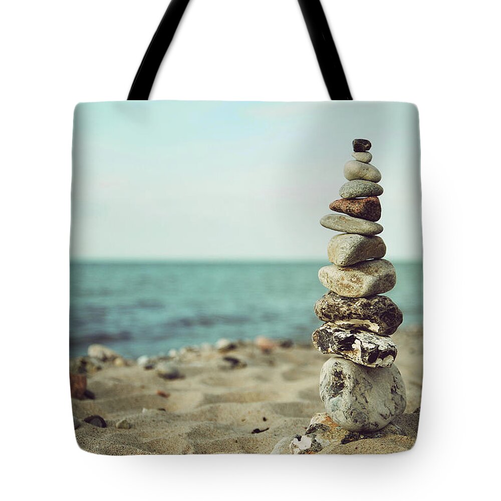 Stones Tote Bag featuring the photograph Poised by Hannes Cmarits