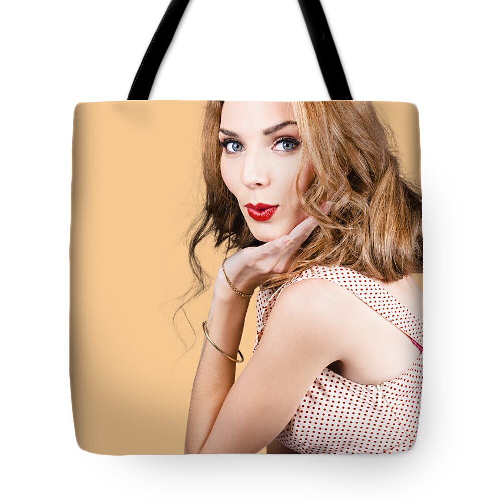 Pinup Tote Bag featuring the photograph Quirky portrait of a posing 50s girl in pinup style by Jorgo Photography