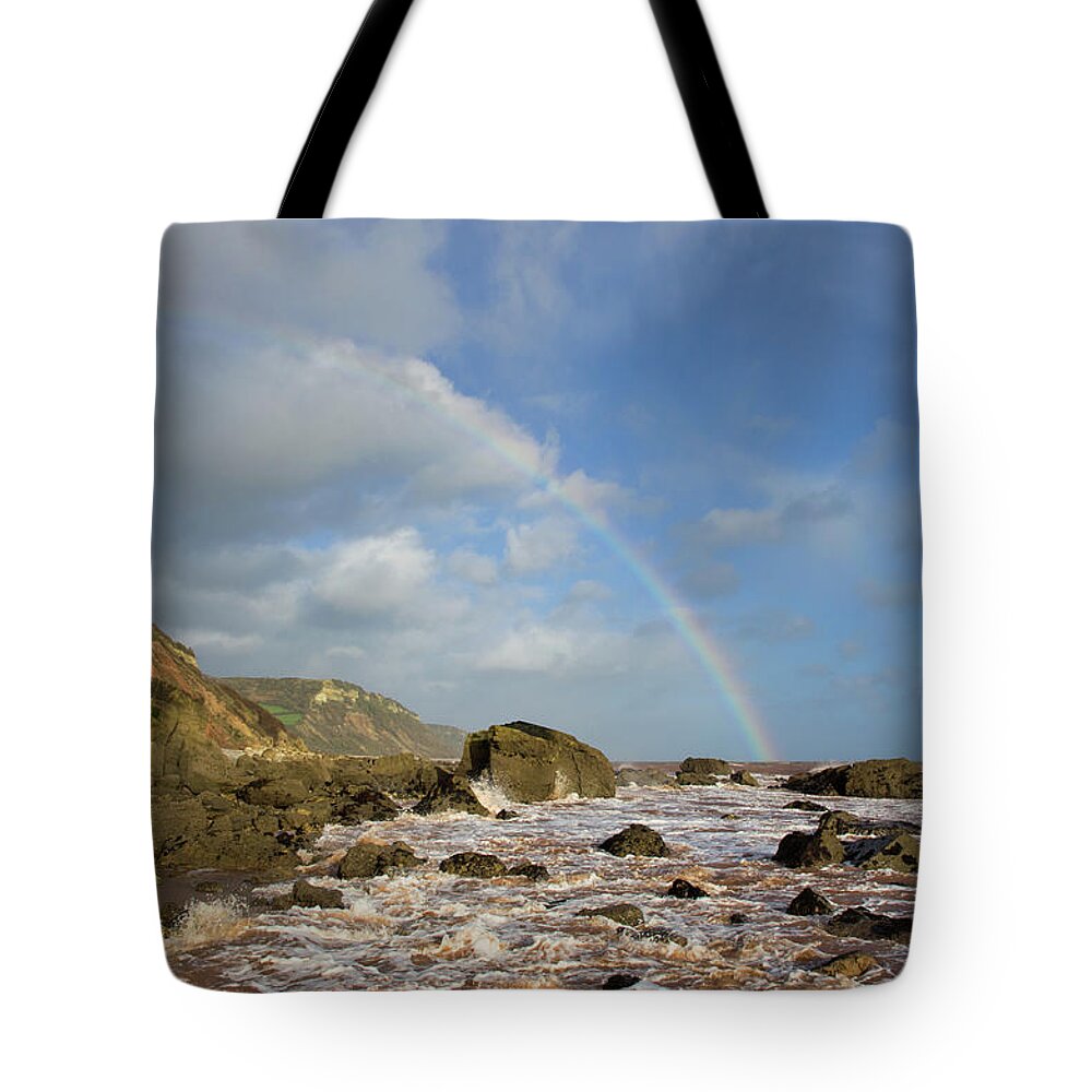 Dunscombe Cliff Devon Tote Bag featuring the photograph Rainbow over Dunscombe Cliff by Pete Hemington