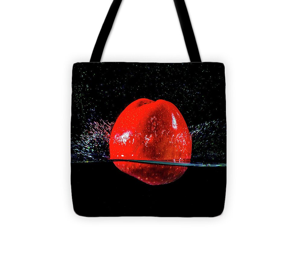 Photograph Tote Bag featuring the photograph Red Apple splash by Terril Heilman