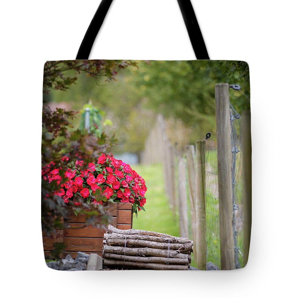 Country Tote Bag featuring the photograph Red flowerd with Fende and wood billet bundle by Amanda Mohler