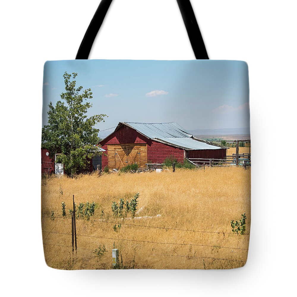 Red Barn; Old Barn; Ranch; High Plains; Idaho; Open; Unlimited; Horizon; Open Spaces Tote Bag featuring the photograph Red Home on the Range by Tom Cochran