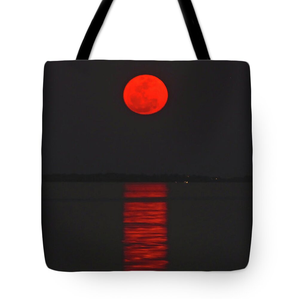 Red Tote Bag featuring the photograph Red Moon Rising by Peggy Urban