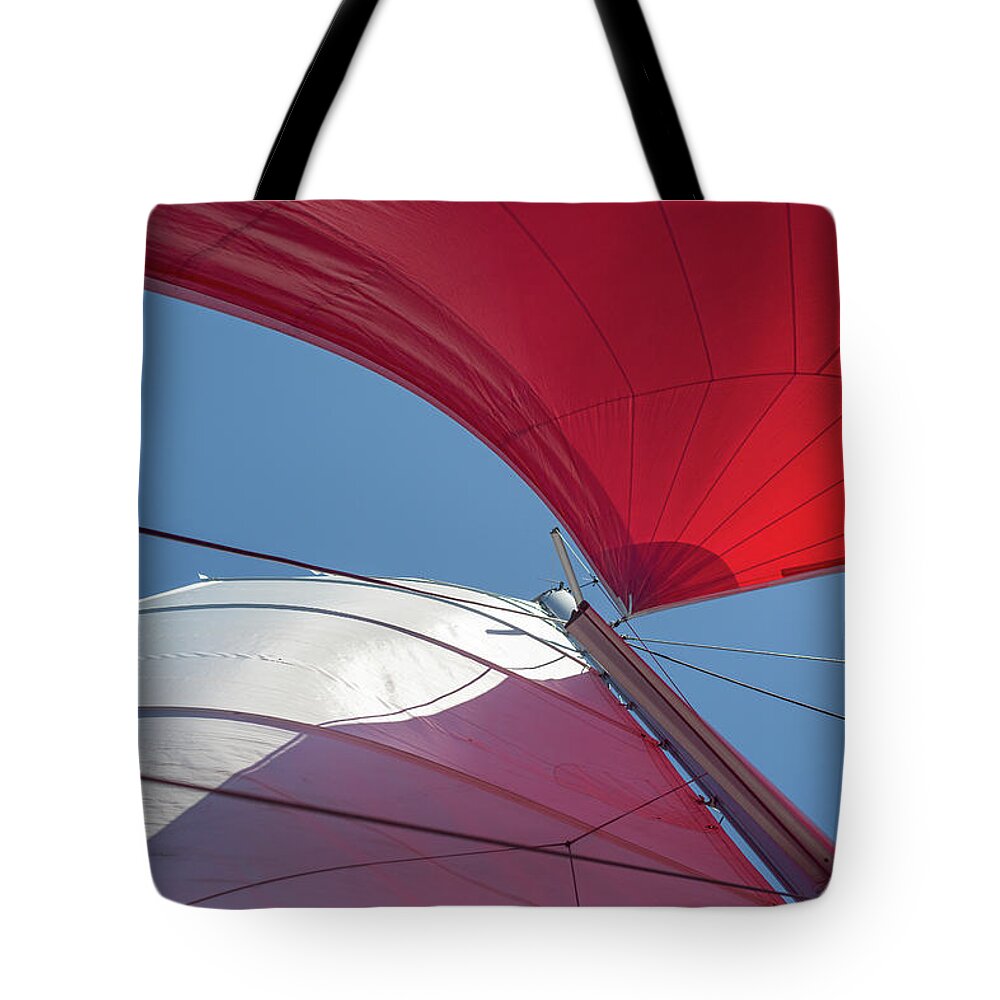 Clare Bambers Stokes Tote Bag featuring the photograph Red Sail on a Catamaran 3 by Clare Bambers