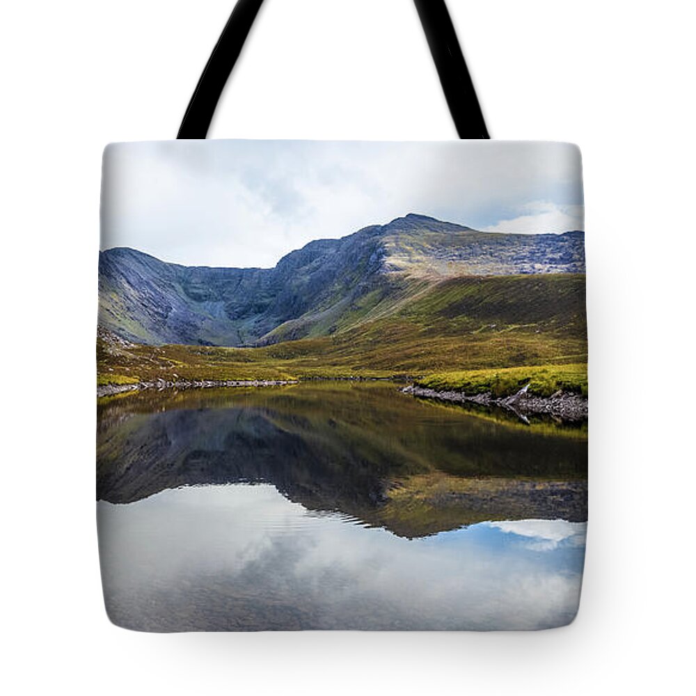 Black Tote Bag featuring the photograph Reflection of the Macgillycuddy's Reeks in Lough Eagher by Semmick Photo