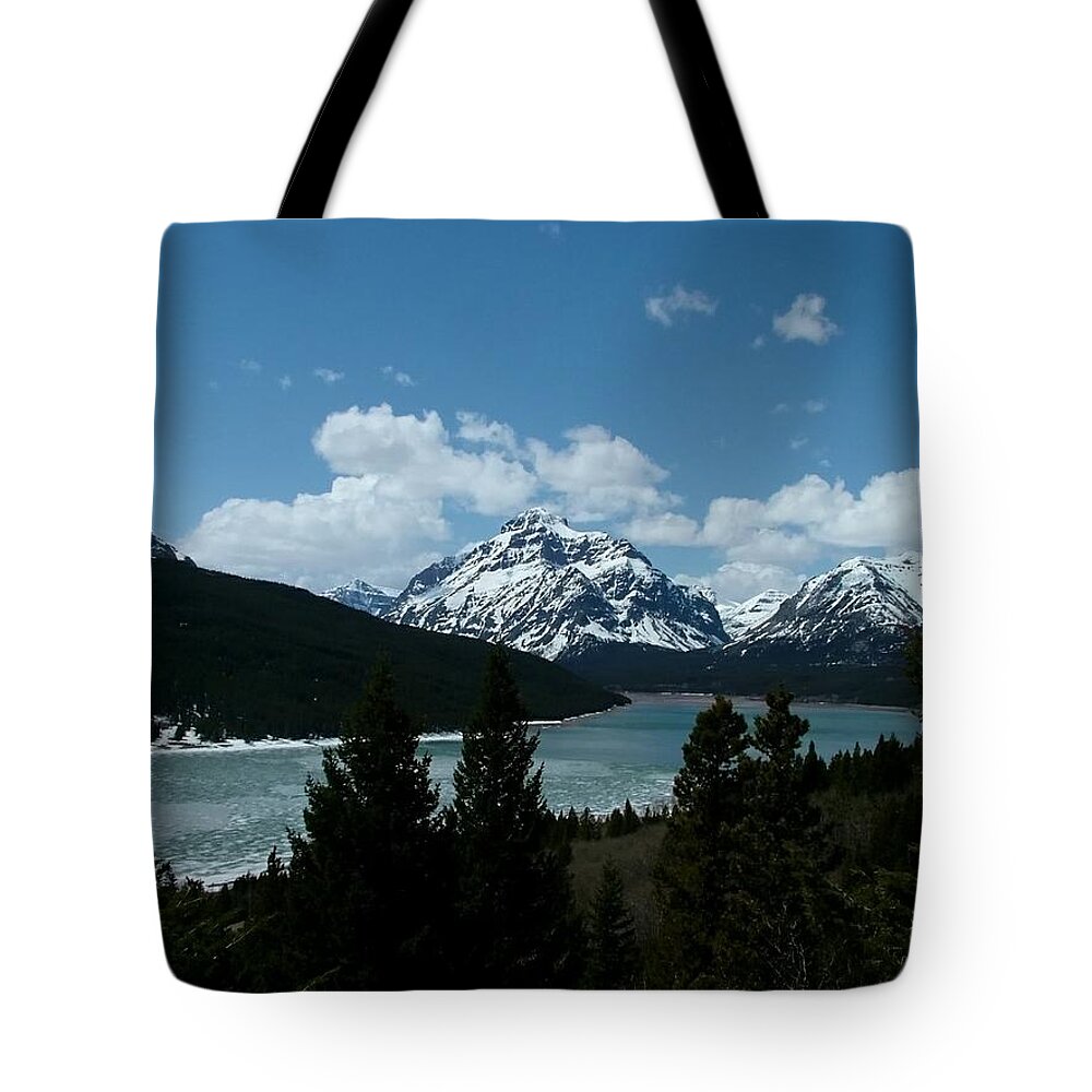 Rising Wolf Mountain Tote Bag featuring the photograph Rising Wolf and Two Medicine Lake by Tracey Vivar