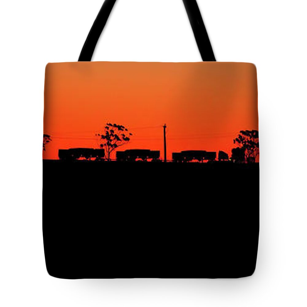 Road Train Sunset Silhouette Woomers Outback South Australia Australian B Double Semi Truck Tote Bag featuring the photograph Road Train Sunset by Bill Robinson