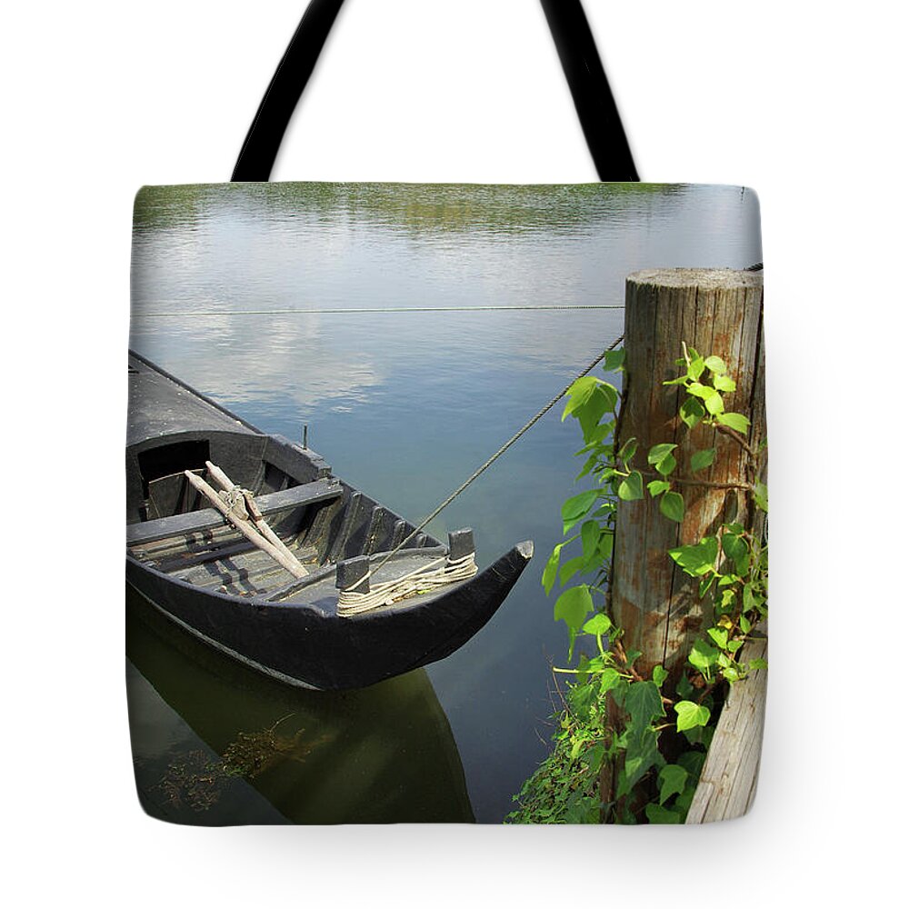 Boat Tote Bag featuring the photograph Row Boat on the shoreline by Carlos Caetano