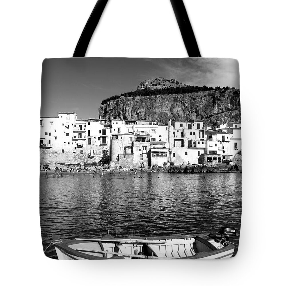Fishing Boat Tote Bag featuring the photograph Rowboat along an idyllic Sicilian village. by Stefano Senise
