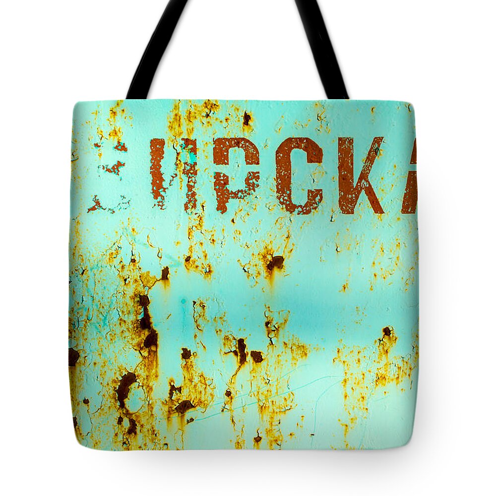 Rusted Metal Tote Bag featuring the photograph Rust on Metal Russian Letters by John Williams