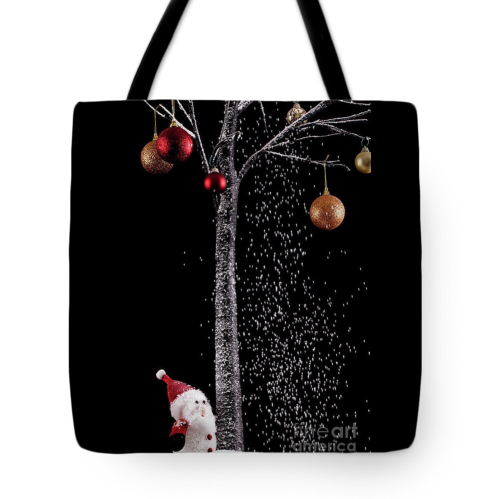 Xmas Tote Bag featuring the photograph Santa under a tree with snow on black background by Simon Bratt