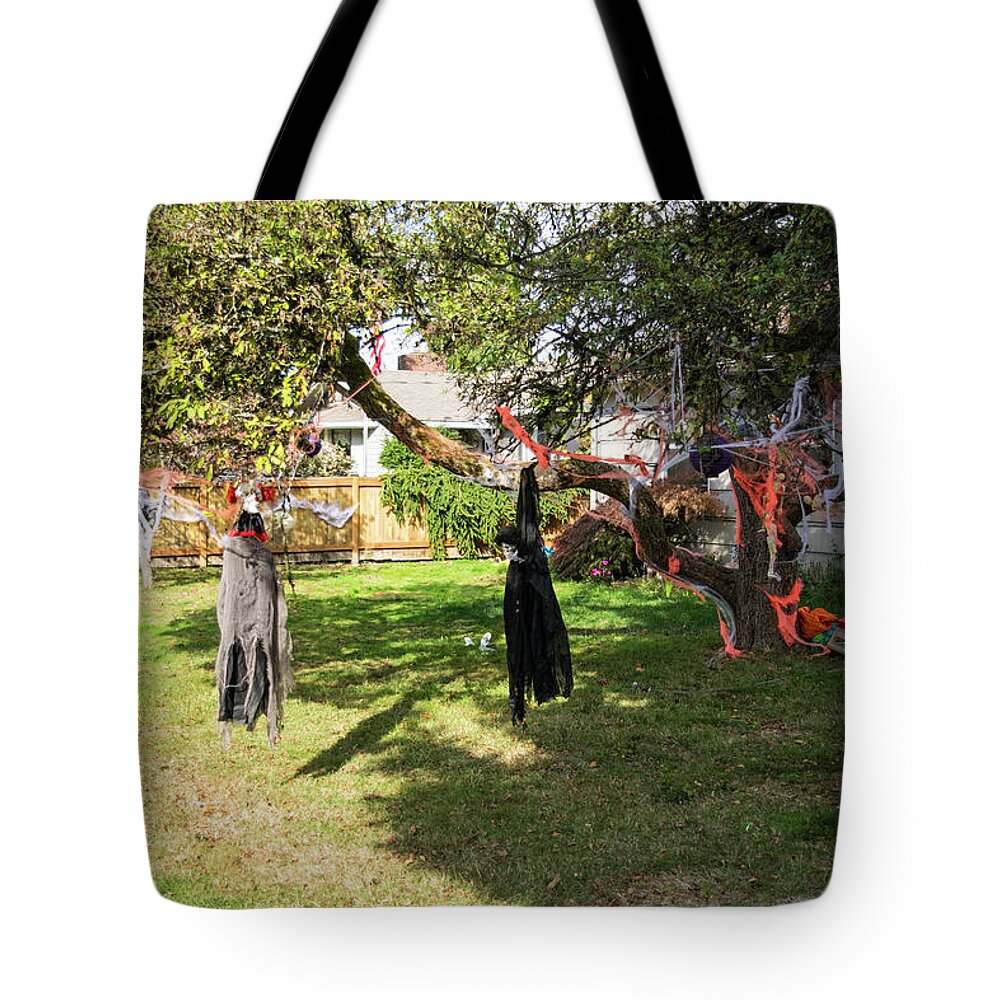 Scary Clown Skeletal Witch And Orange Cobwebs Tote Bag featuring the photograph Scary Clown Skeletal Witch and Orange Cobwebs by Tom Cochran