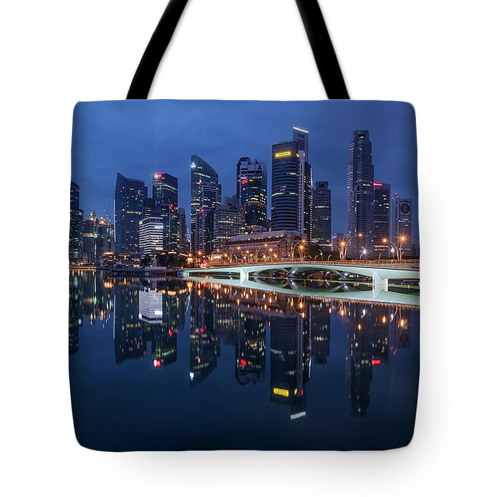 Lights Tote Bag featuring the photograph Singapore skyline reflection by Pradeep Raja Prints