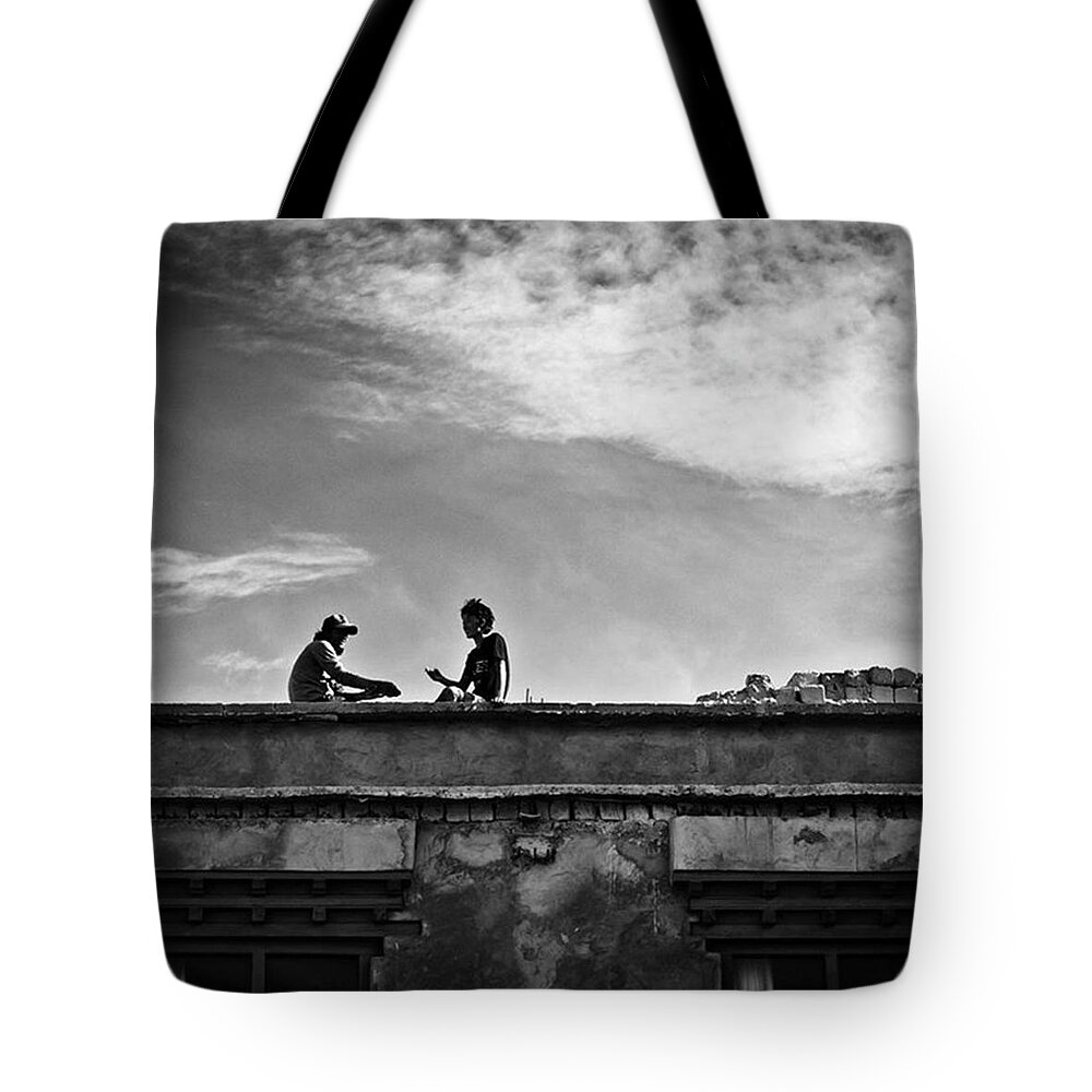 Twoboys Tote Bag featuring the photograph Sitting On The Roof Having A Chat, India by Aleck Cartwright