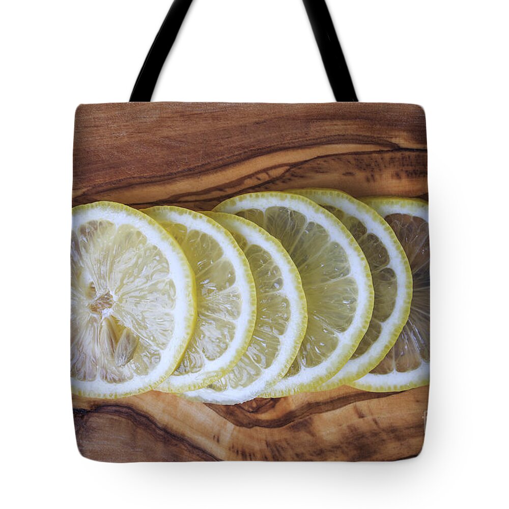 Lemons Tote Bag featuring the photograph Slices of lemon by Edward Fielding