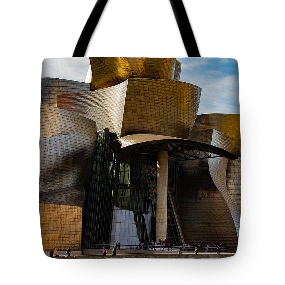 Spain Bilbao Guggenheim Museum Basque Country Frank Gehry Contemporary Architecture Nervion River City Daring And Innovative Curves Building Exterior Spectacular Building Deconstructivism Ferrovial Clad In Glass Tote Bag featuring the photograph The Guggenheim Museum Spain Bilbao by Andy Myatt