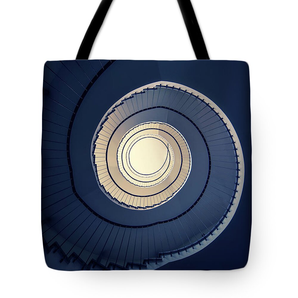 Spiral Staircase Tote Bag featuring the photograph Spiral staircase in blue and cream tones by Jaroslaw Blaminsky