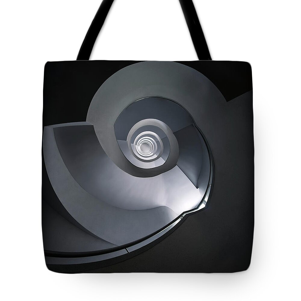 Spiral Staircase Tote Bag featuring the photograph Spiral staircase in grey and blue tones by Jaroslaw Blaminsky