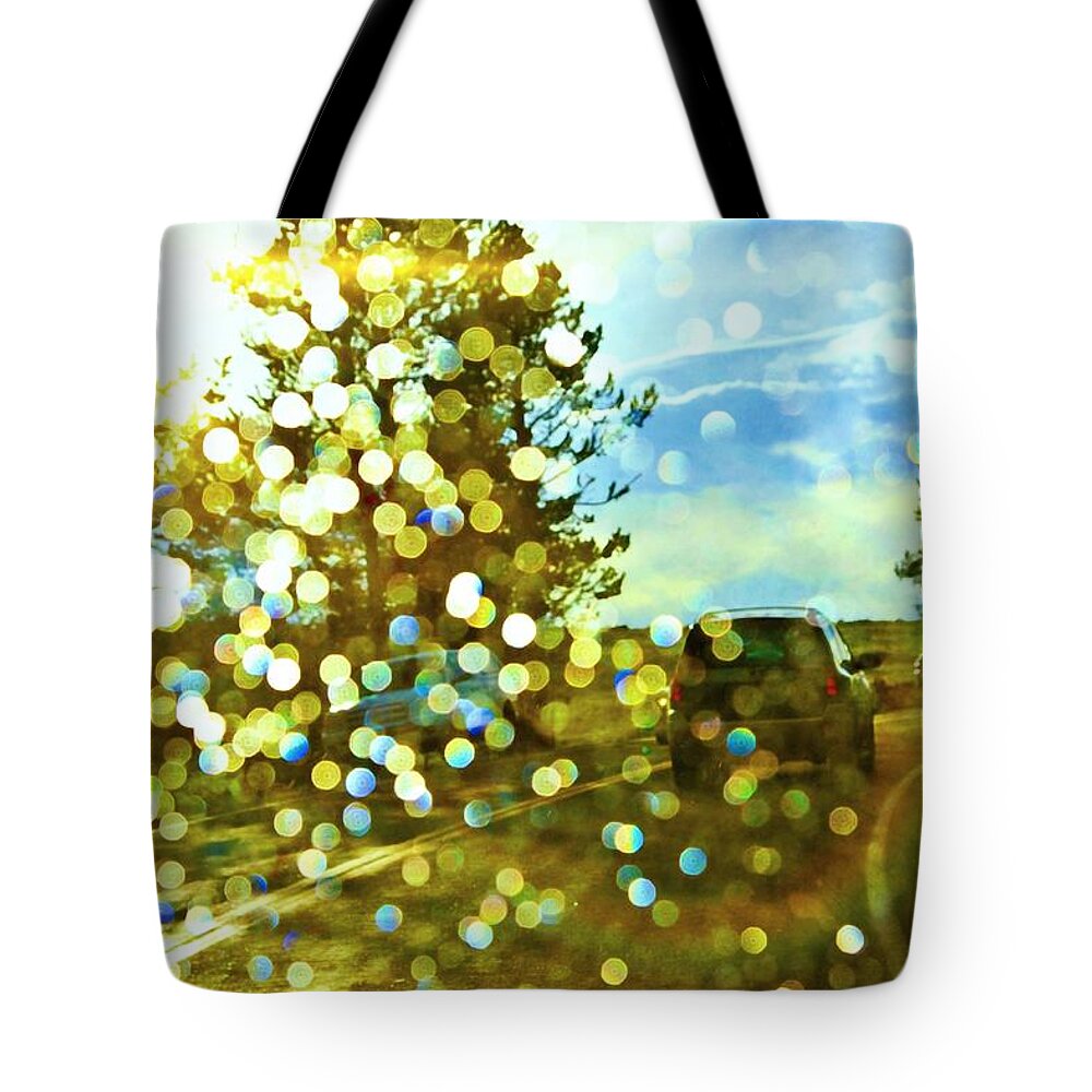 Yellowstone National Park Tote Bag featuring the photograph Spots of light by Tatiana Travelways