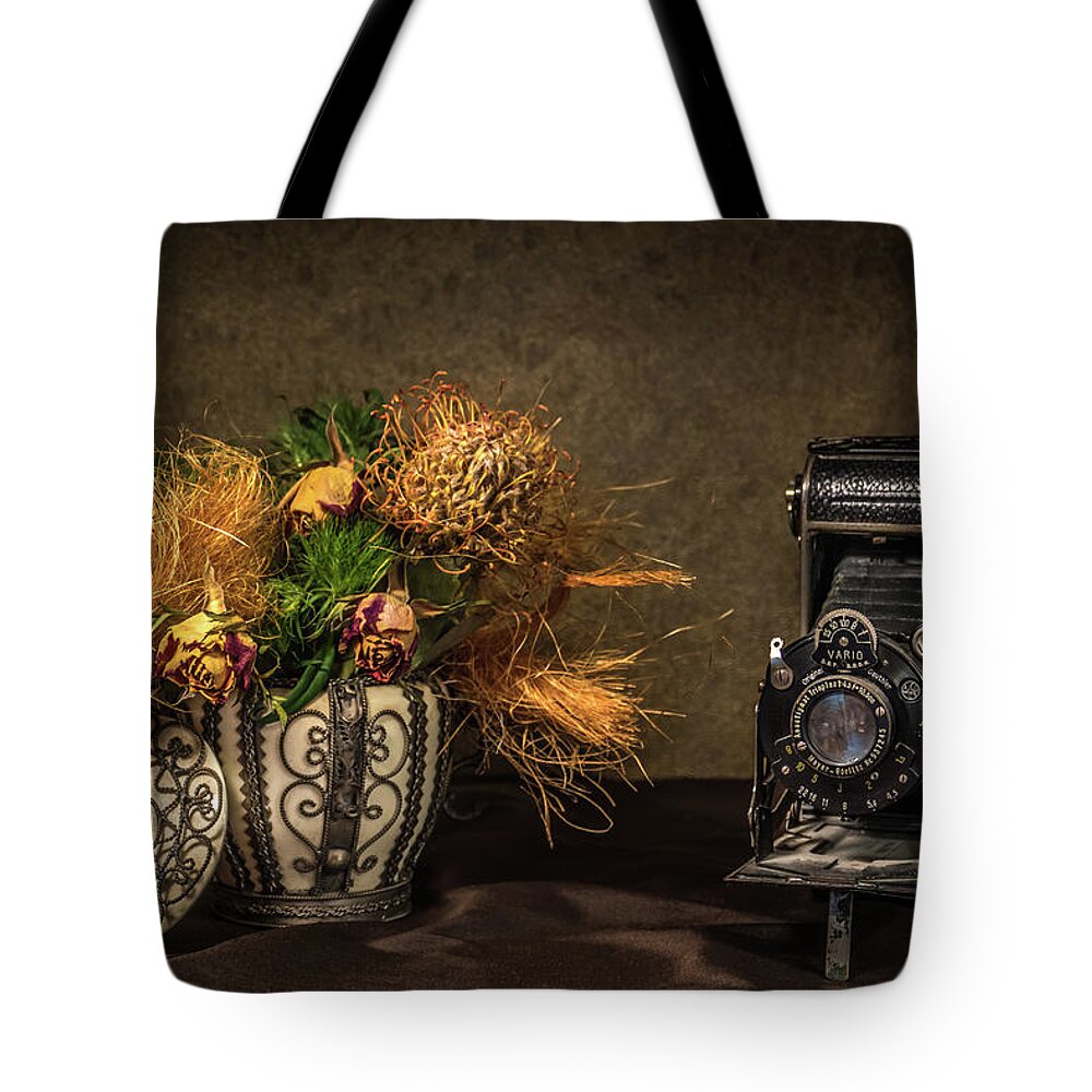 Still Life Tote Bag featuring the photograph Still Life with Flowers and Camera by Wim Lanclus