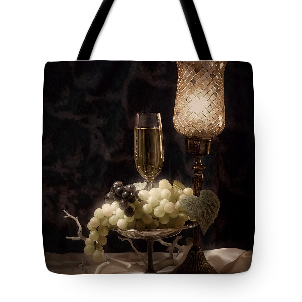 Alcohol Tote Bag featuring the photograph Still life with wine and grapes by Tom Mc Nemar
